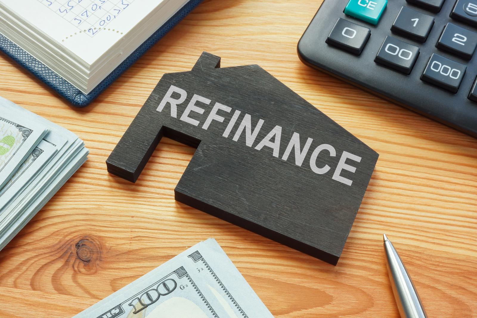 Refinance home mortgage concept. The Model of house on the table.